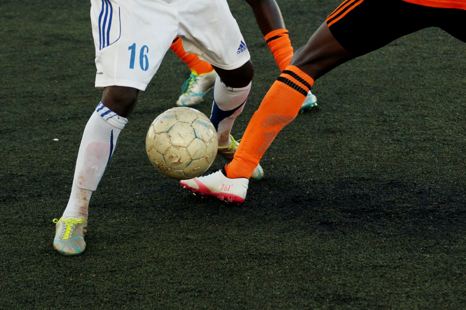Two legs going for the ball